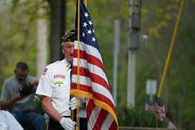Veteran carrying American flag